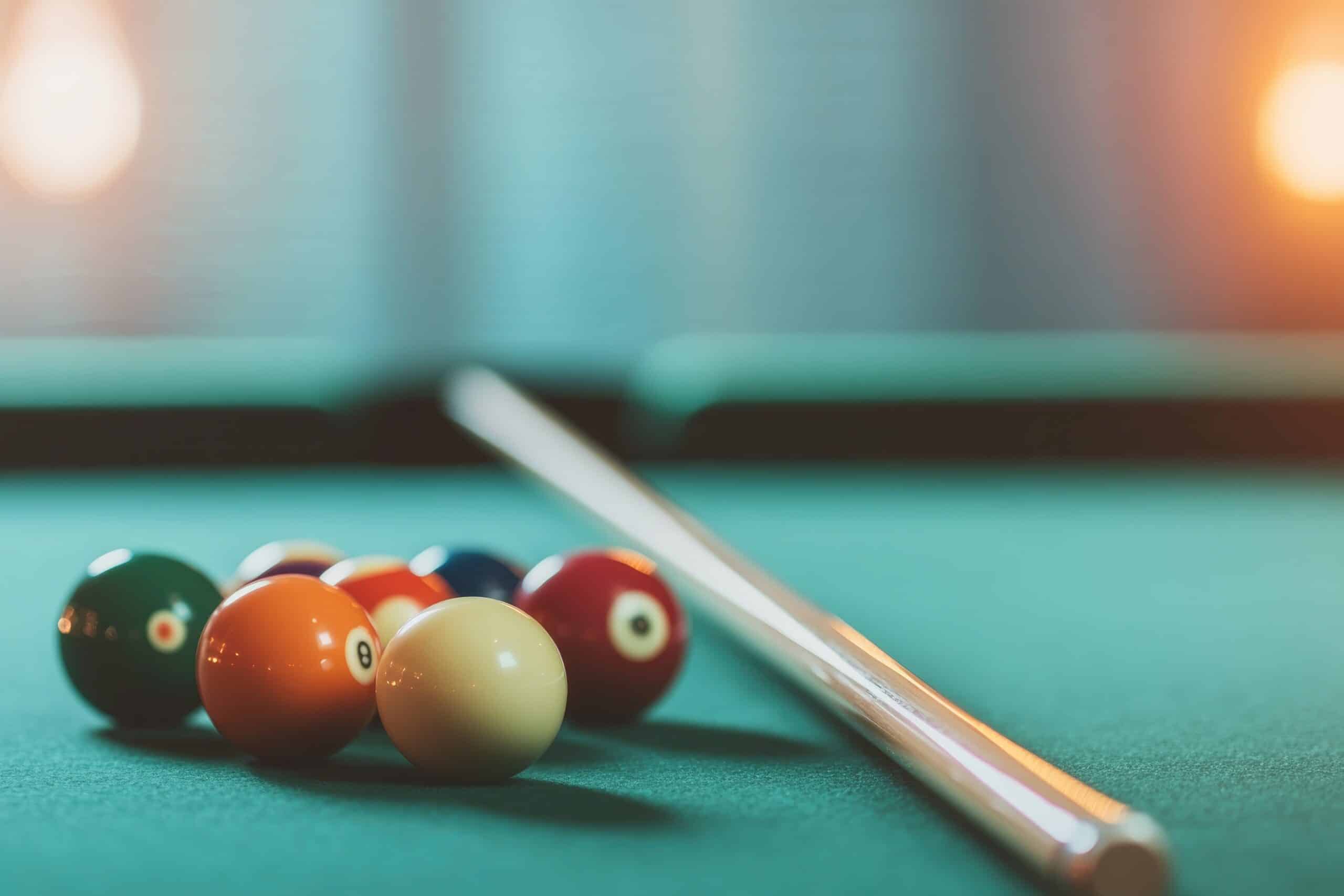dimly lit billiards table